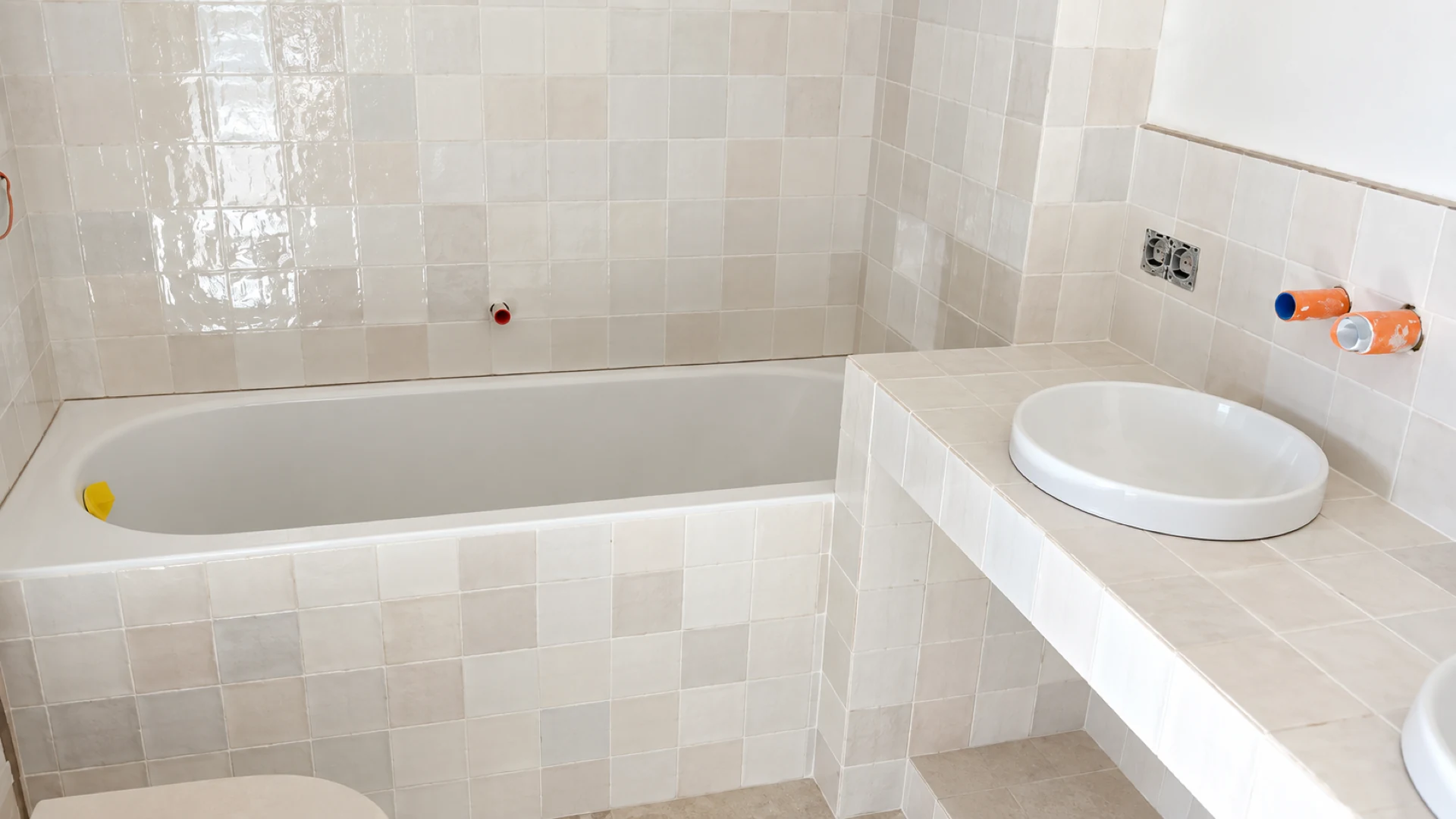 Baignoire et plan carrelé en faïence blanche